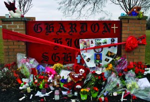 Memorials placed in front of the Chardon High School sign in the aftermath of the Feb. 27, 2012 shooting which claimed the lives of three students.