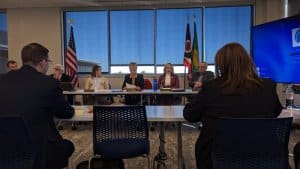 AMY PATTERSON/KMG Geauga Public Health board members Lynn Roman, left, and Carolyn Brakey read from statements regarding their presentation of a plan to join an agreement with the Lake County General Health District during a March 15 special meeting.